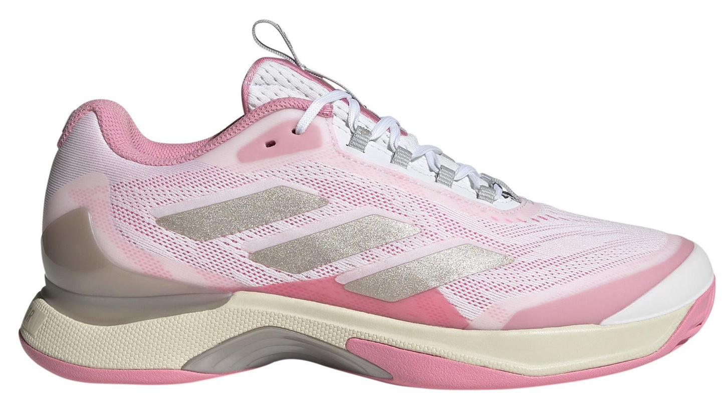 The ADIDAS Avacourt 2 women's tennis shoes feature a white and pink design with silver accents, textured sole, and a Bounce Pro midsole. They have a lace-up design crafted from recycled materials and a low-top silhouette, perfect for sports or casual wear. Ideal for active lifestyles.