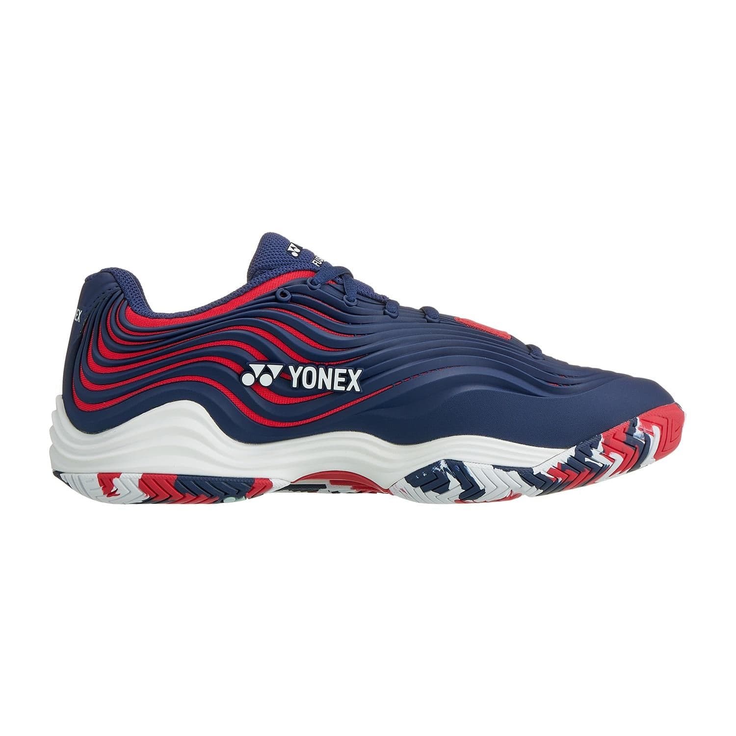 The Yonex Power Cushion FusionRev 5 Men's Tennis Shoes in navy and red boast a bold design with wavy upper patterns. They are equipped with a Power Cushion and a multicolored outsole featuring red, blue, and white accents, offering both comfort and style.