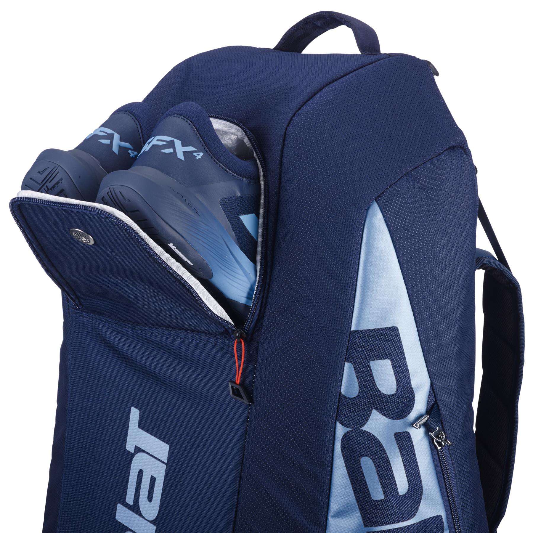 The Babolat RH6 Pure Drive Gen11 tennis bag in navy blue offers ample space, a partially unzipped compartment for shoes, and includes a handle and shoulder strap—ideal for athletes.