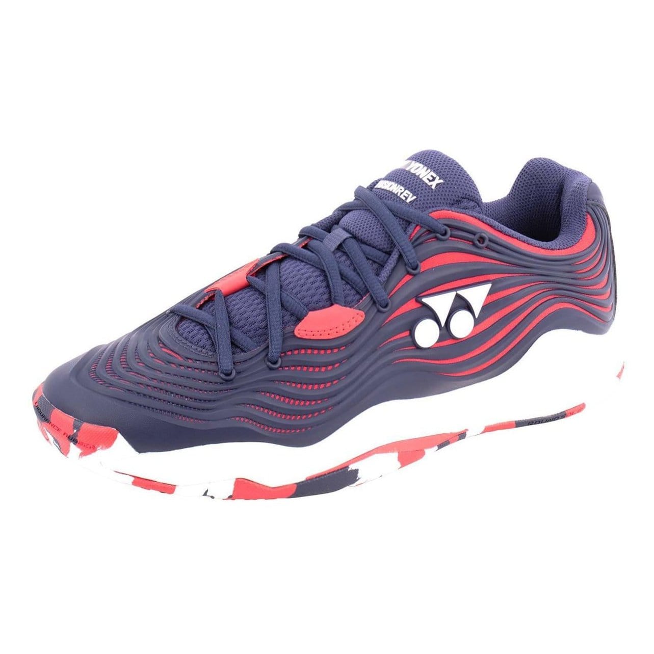 The Yonex Power Cushion FusionRev 5 Men's Tennis Shoes in Navy and Red offer a wave-like design with white and red accents, highlighted by the distinctive Yonex logo on the side. Designed for enhanced comfort, they feature the brand's renowned Power Cushion technology. The sole stands out with a bold camouflage pattern in red, white, and navy.