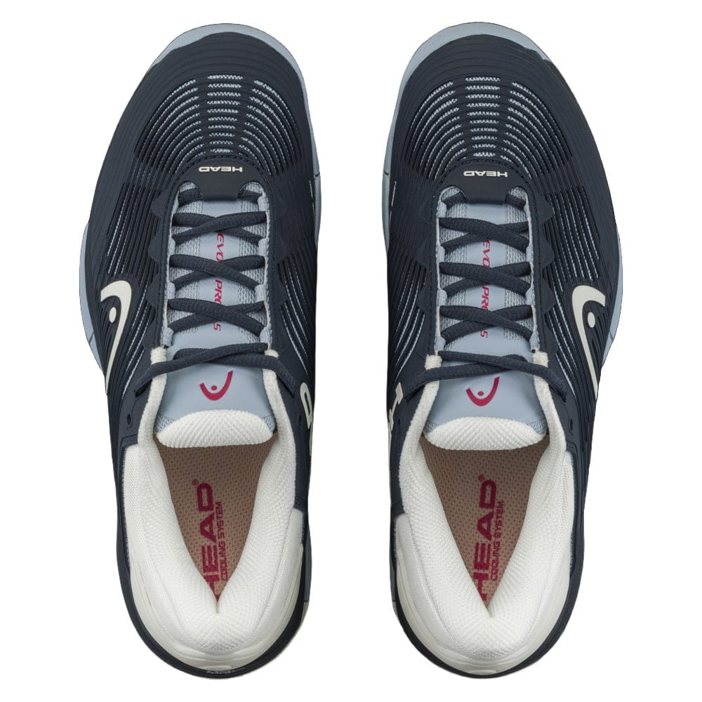 Top view of a pair of blueberry and light blue tennis shoes with laces. The insoles are branded with the logo "HEAD" in red. Designed for stability, the HEAD Revolt Pro 4.5 Womens Tennis Shoes feature a sleek design with pattern details on the sides, integrating performance technologies for enhanced play.