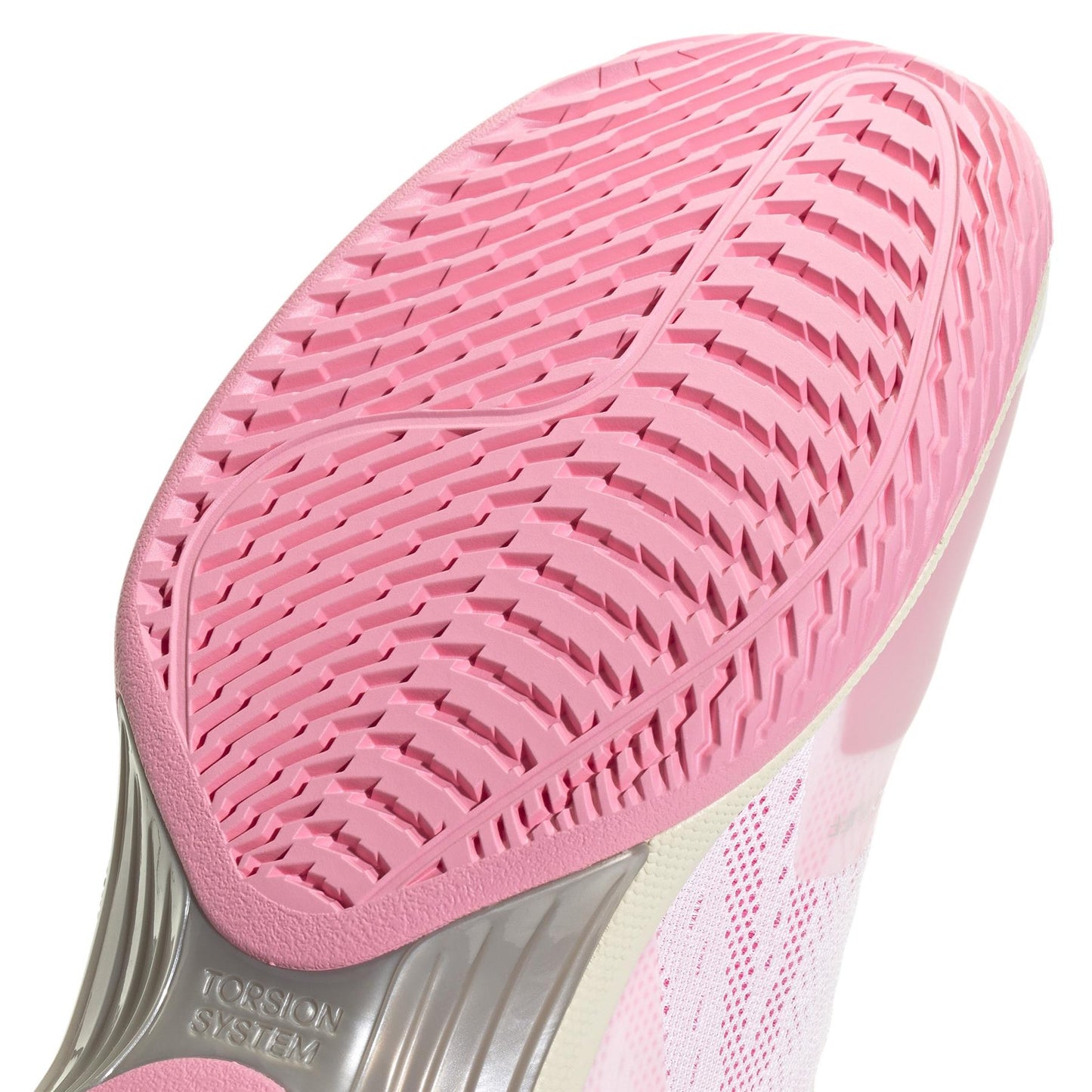 Close-up of a pink sneaker sole with intricate tread patterns. The adidas ADIDAS Avacourt 2 Women's Tennis Shoes in White/Pink feature a "Torsion System" design for flexibility and support, with responsive cushioning for optimal comfort.