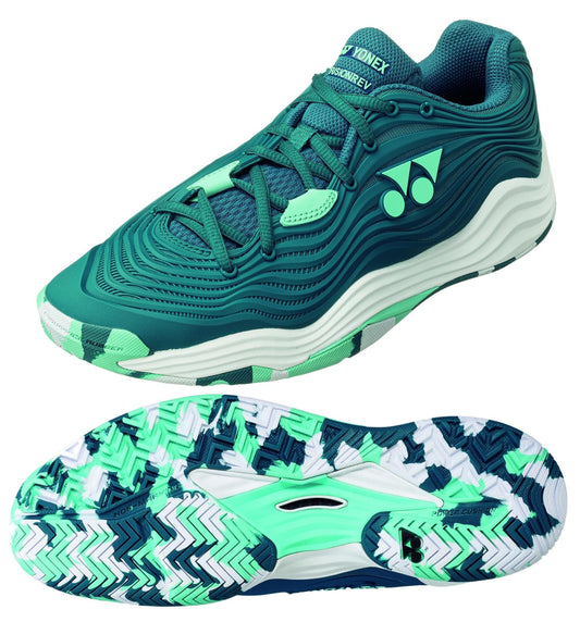 The Yonex Power Cushion FusionRev 5 men's tennis shoes in blue and green feature a wavy design and unique tread pattern, enhanced by a TPU Shank for stability. Featuring a white logo and a mix of light and dark shades, these shoes present a sporty, dynamic appearance powered by innovative Power Cushion technology.