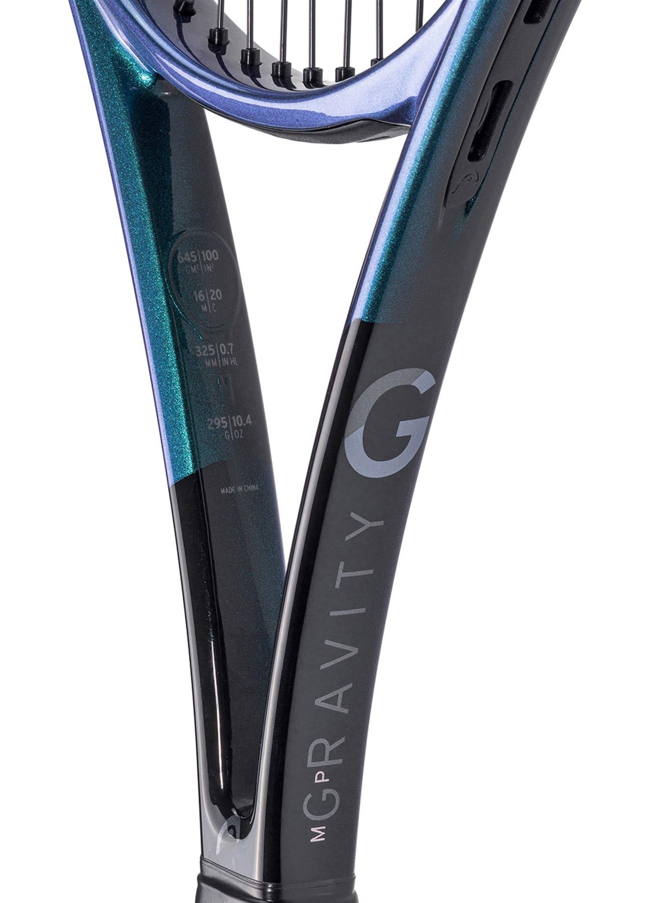 Close-up of the HEAD Gravity MP 2025 Tennis Racket throat, featuring a glossy black frame. "GRAVITY" is printed vertically, highlighting its innovative Auxetic 2.0 tech. Strings peek at the top, a choice of tennis stars Alexander Zverev and Andrey Rublev.