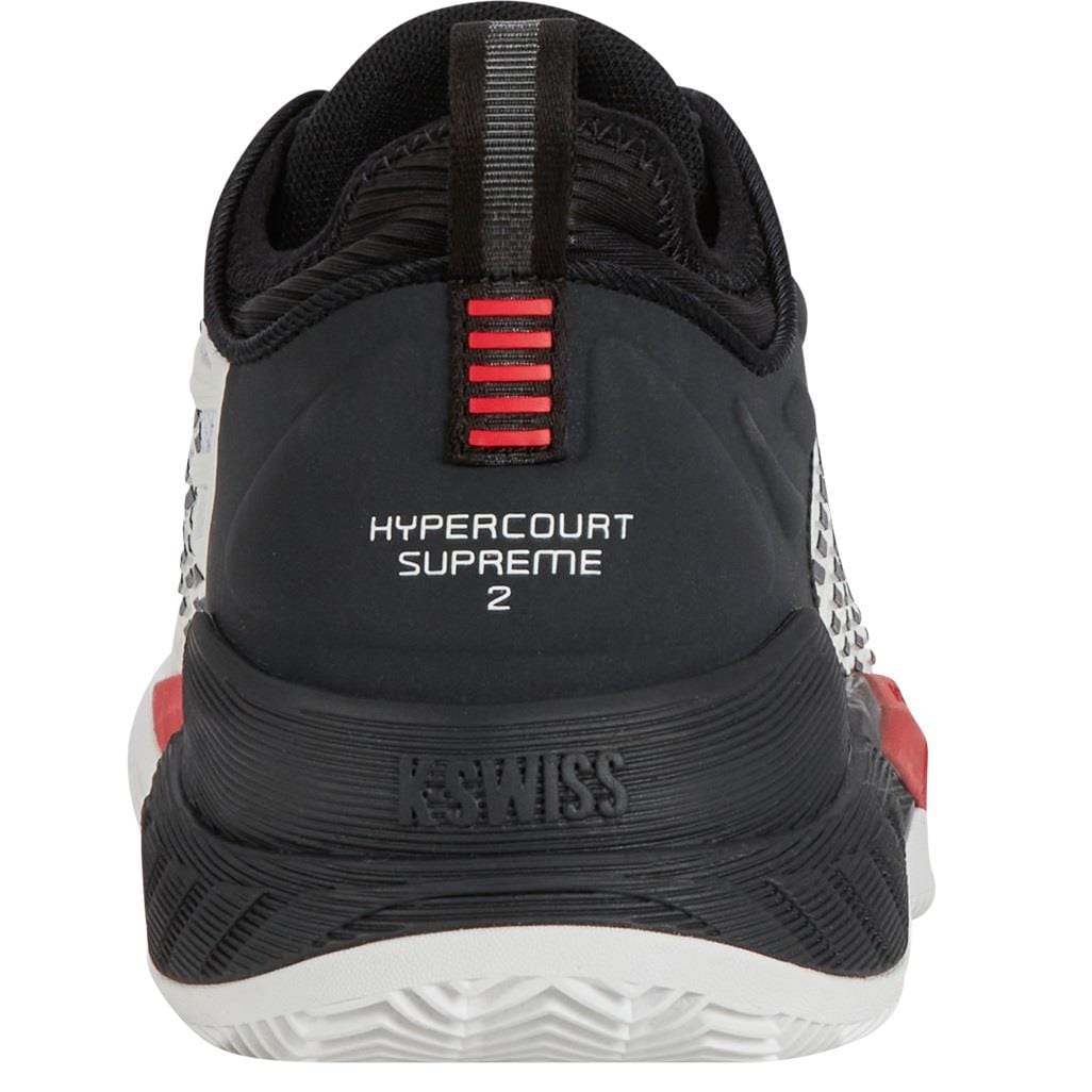 Rear view of the K-Swiss Hypercourt Supreme 2 Men's Tennis Shoes in Bright White, Stretch Limo, and High Risk Red. This sleek shoe features a white sole with black and red accents, incorporating Durawrap X technology for enhanced durability. The K-Swiss brand name is prominently displayed on the heel above the textured detailing.