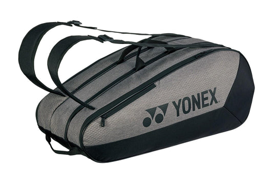 The Yonex 42529EX Team 9 Racket Tennis Bag in gray and black boasts two shoulder straps, an oval shape, multiple zippered compartments, and a side Yonex logo—ideal for transporting all your tennis gear.