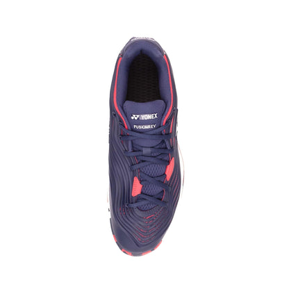 Here's a top view of the Yonex Power Cushion FusionRev 5 Men's Tennis Shoes in navy and red. The shoe is predominantly dark blue, highlighted by red accents on the laces and trim. It boasts a textured surface design and is equipped with Power Cushion technology, enhancing comfort and performance on the court.