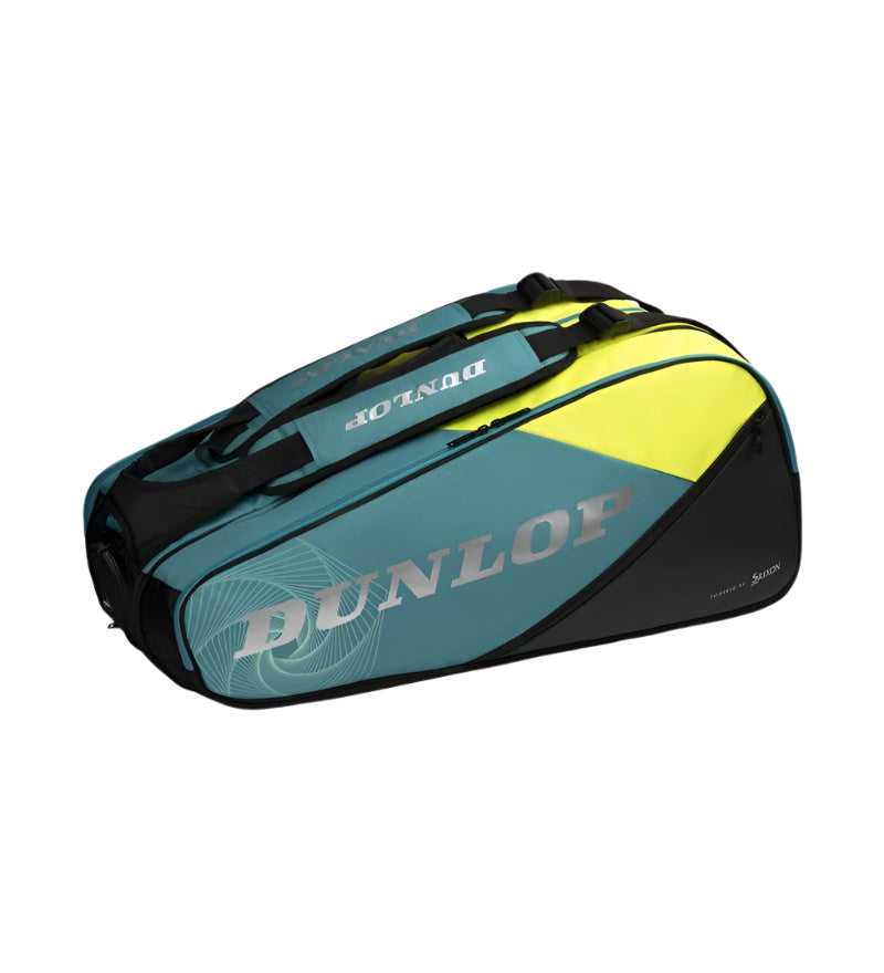 The Dunlop SX Performance 12 Racket Tennis Bag in teal, black, and yellow features ergonomic shoulder straps, multiple compartments, and sturdy handles for easy carrying.