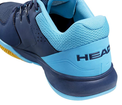 Description of the HEAD Grid 3.5 Indoor Court Tennis Shoes in Dark Blue and Aqua: The shoe features a close-up design with "HEAD" prominently displayed on the heel. Its textured, breathable mesh upper shines in light blue, complemented by darker blue and black accents. Comfort is assured with an EVA midsole, while the yellow edge of the sole subtly stands out.