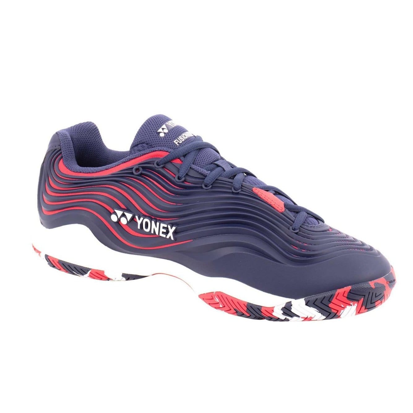 The Yonex Power Cushion FusionRev 5 men's tennis shoe in navy and red captivates with its stylish accents, wavy pattern design, and vibrant multi-colored sole. Featuring Power Cushion technology, it ensures remarkable comfort and agility on the court.