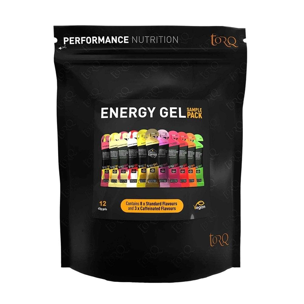 The elegant black packaging highlights the Torq Gel Sample Pack - Assorted 12 Pack, featuring a selection of 12 sachets with multi-transportable carbohydrates in a variety of flavors. This pack includes 9 standard and 3 caffeinated options and underscores its vegan-friendly performance nutrition advantages, which are essential components of the Torq Fuelling System.