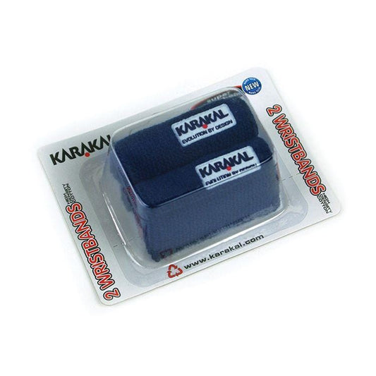 Two navy Karakal Tennis Wristbands in retail packaging, featuring the "Karakal" brand name on a white background. The packaging states "Karakal Tennis Wrist Band (Twin Pack)," highlighting a small embroidered logo. These super absorbent wristbands are ideal for tennis enthusiasts looking for both performance and style.