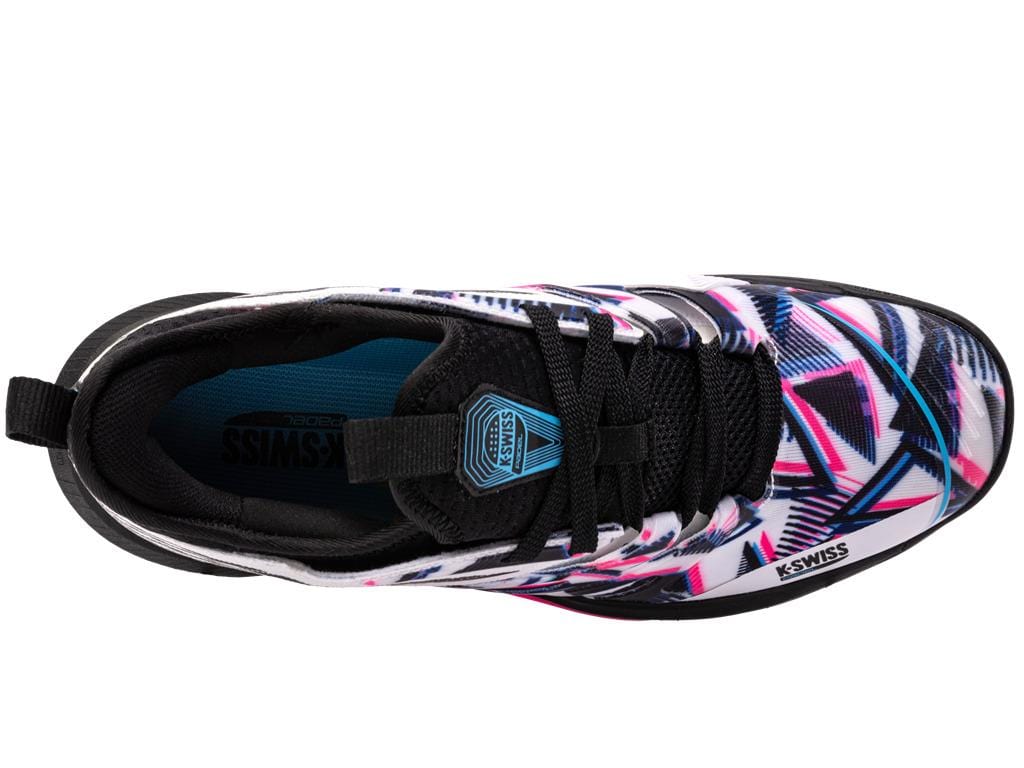 Top view of the K-Swiss Speedtrac Indoor Court Shoes showcasing a geometric pattern in white, black, and neon pink. These shoes feature a black lace area, a branded tongue, lightweight midfoot support, and a sturdy design.