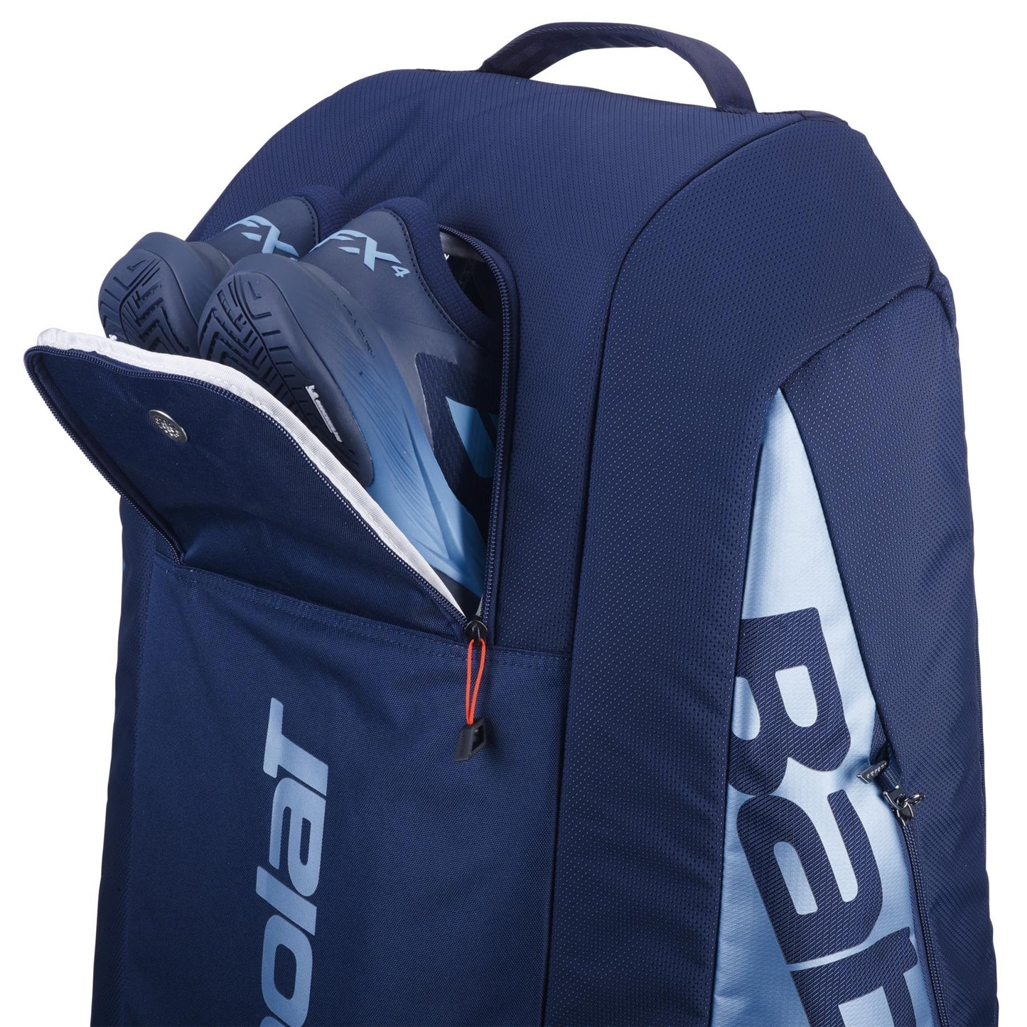 The navy blue Babolat RH12 Pure Drive Gen11 bag for 12 rackets has insulated compartments plus a separate, partially open shoe section displaying blue tennis shoes. It features zippers and snap closures with a convenient top carry handle.