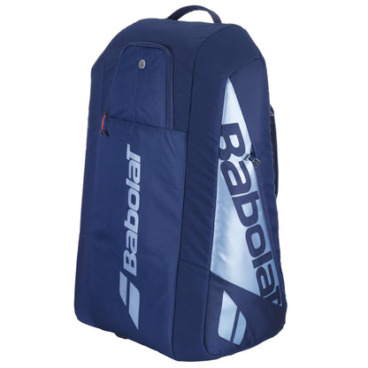 The Babolat RH12 Pure Drive Gen11 Tennis Bag in Navy Blue features a vertical white Babolat logo on a light blue strip. With a top handle, insulated compartments for 12 rackets, and multiple zippered sections, it's ideal for sports or tennis gear with its large capacity design.