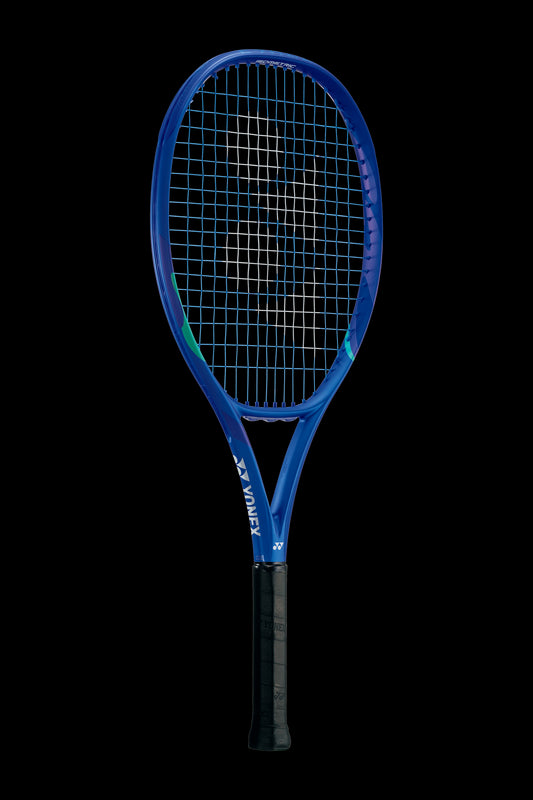 The Yonex EZONE 26 Junior Graphite 2025 Tennis Racket, in Blast Blue, features a blue frame with a black grip and white strings, elegantly showcased upright against a black background.