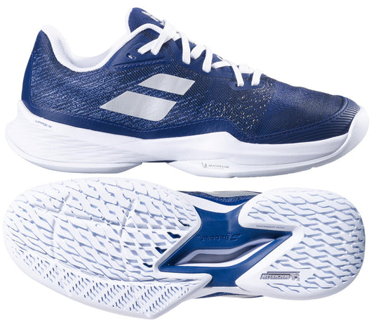 The Babolat Jet Mach 3 All Court 2025 Women's Tennis Shoes in dark blue boast a Michelin sole for grip and durability, featuring two white diagonal stripes, a textured sole, and mesh detailing for breathability.