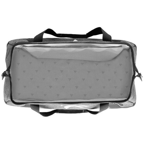 The top view of the Tecnifibre All Vision Tennis Duffle Bag - Grey reveals a spacious rectangular design with a transparent lid and wide-angle opening. Inside, it showcases a repeating pattern of small triangular symbols, making it ideal for racquet sports enthusiasts. The bag is finished with sleek black handles and zippers, reflecting the quality of the Tecnifibre brand.