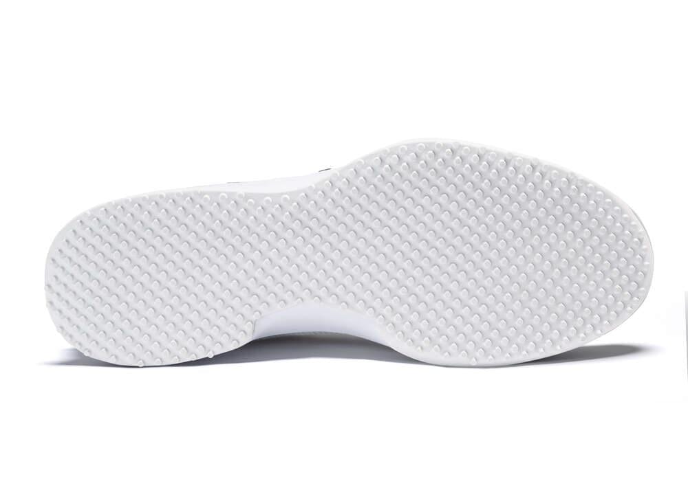 The image displays the underside of the HEAD Sprint Pro 3.0 Men's Grass Court Tennis Shoes in White/Grey, showcasing Hybrasion+ Technology with a textured surface and uniformly distributed raised bumps across the outsole.