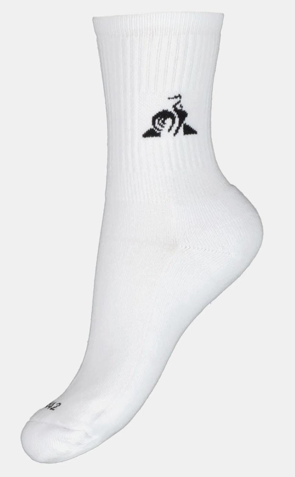 Displayed on a mannequin foot, the Le Coq Sportif Mens Tennis Socks in white feature a black snail logo with a swirl pattern near the top. These socks from Le Coq Sportif boast moisture-wicking technology, ribbed detailing, and a reinforced heel and toe area, making them perfect for tennis enthusiasts.