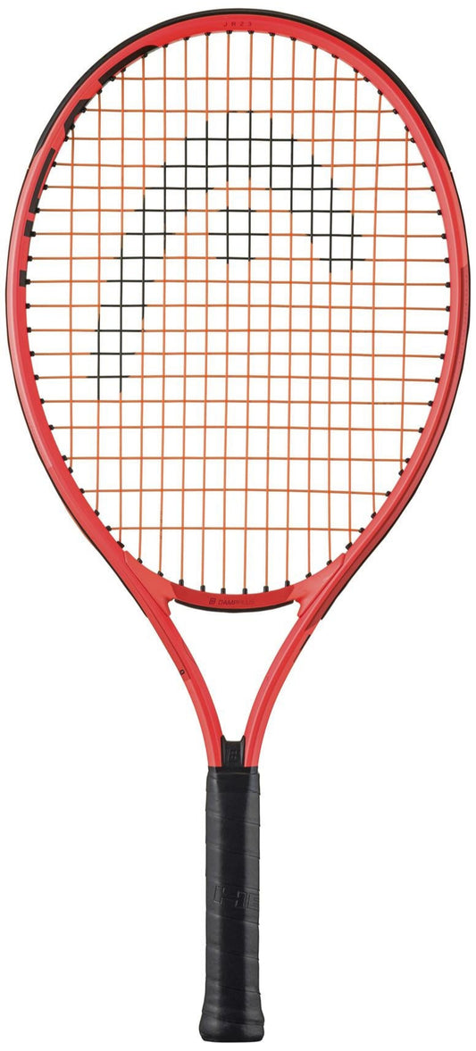 The HEAD Radical Junior 23 2025 Tennis Racket - Orange features a striking design with a red frame, black handle, and vibrant orange strings forming a logo pattern. Captured on a white background, it also includes the Damp+ insert for enhanced shock absorption.