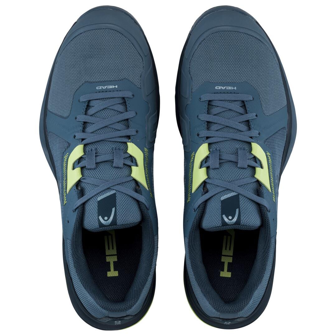 A pair of blue athletic shoes featuring the HEAD brand logo displayed from above. These lightweight and breathable tennis shoes, known as the HEAD Sprint Team 3.5 Men's Tennis Shoes, are set on a plain white background, highlighting their mesh texture and stylish design.