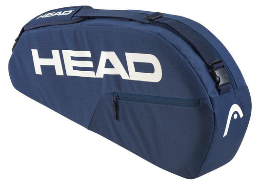 The HEAD BASE 3 Racket Tennis Bag S - NV is blue with a large white "HEAD" logo. It features a zippered compartment, adjustable shoulder carry system, and reinforced construction for durability, making it perfect for securely carrying all your tennis equipment.