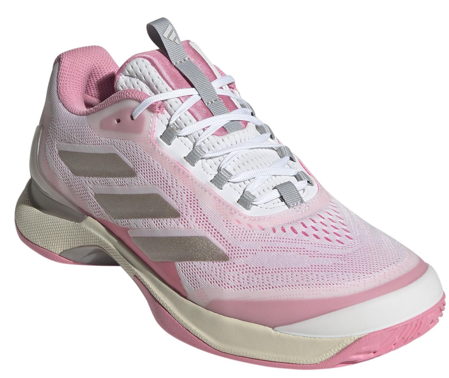 The ADIDAS Avacourt 2 Women's Tennis Shoes blend white and pink with gray stripes, featuring mesh fabric and a light gray/pink sole. Designed for comfort with responsive cushioning, these shoes use recycled materials and come with white laces plus a tongue loop for easy adjustment.