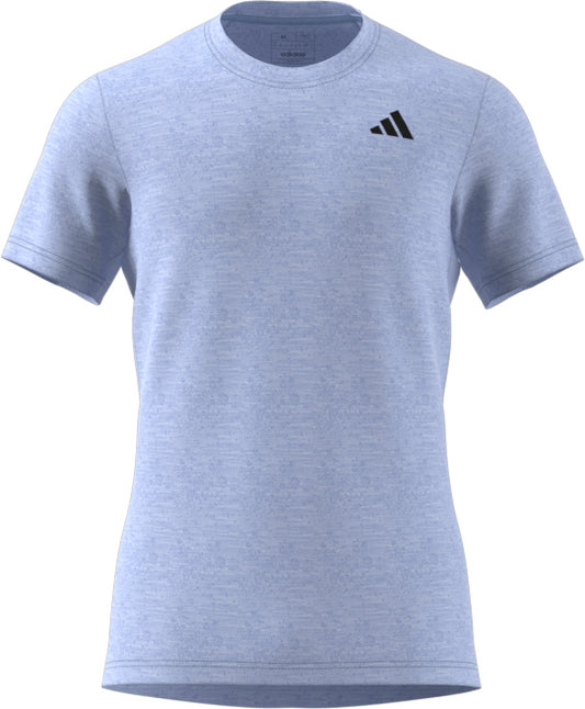 Check out the Men's Freelift Tennis T-Shirt by adidas in Blue Dawn, designed with AEROREADY technology to keep you cool. This short-sleeved tee features a subtle heather pattern and a discreet black Adidas logo on the left chest, offering an effortlessly stylish and comfortable fit.