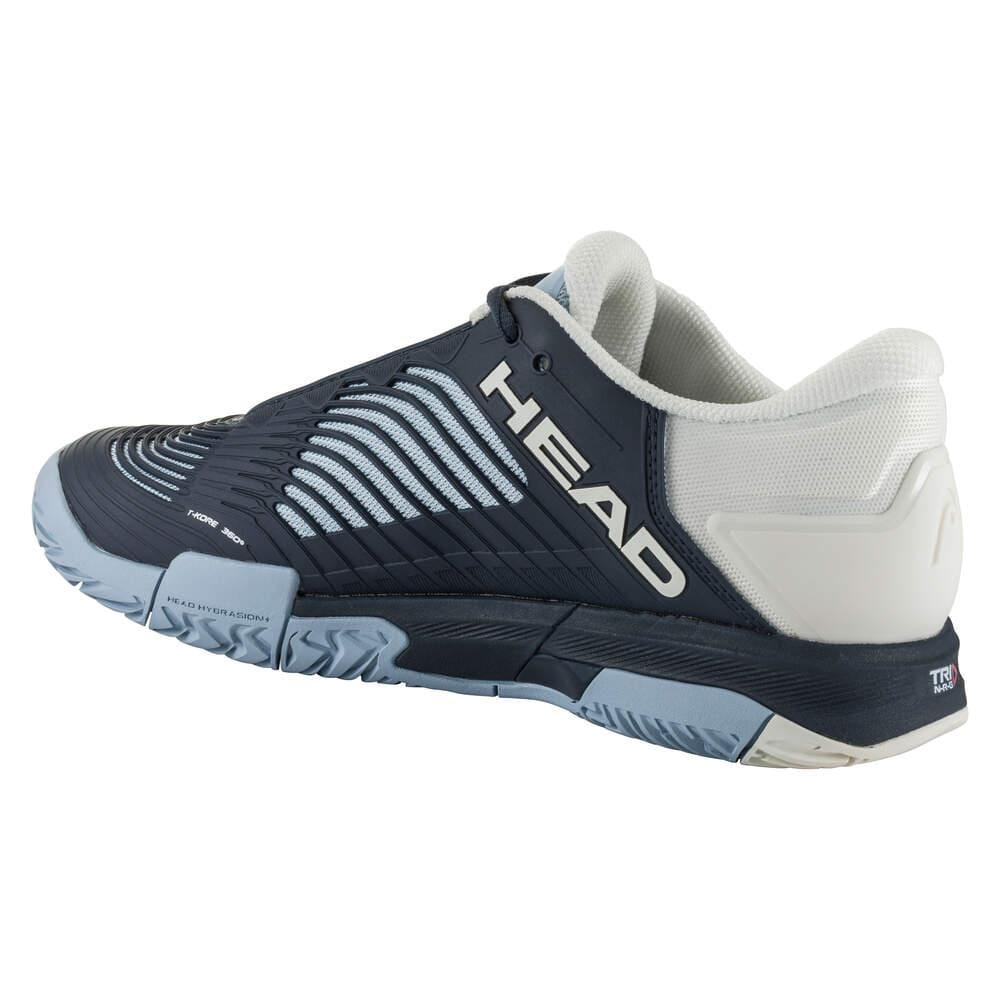 The HEAD Revolt Pro 4.5 Women's Tennis Shoes in Blueberry and Light Blue offer stability and a textured design, prominently featuring the "HEAD" branding on the side. Equipped with a chunky sole, these shoes are ideal for sports or casual wear. The cushioned inner lining ensures comfort, enhanced by performance technologies.