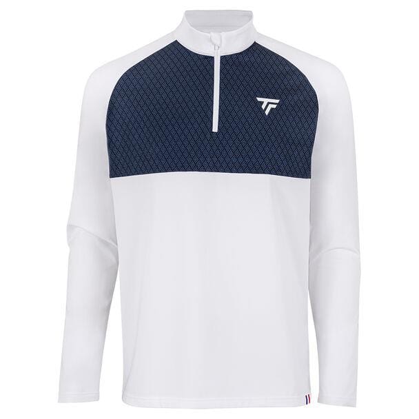 The Tecnifibre Men's Thermo Tennis Zipper Longsleeve - White features a stretchy knit design with a crisp white lower area and a dark blue patterned upper section. This stylish piece is equipped with raglan sleeves, a quarter-zip collar, and is adorned with a small chest logo, ensuring both style and flexibility for any athlete.