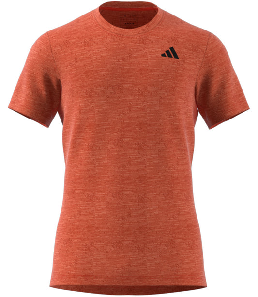 This red ADIDAS Men's Freelift Tennis T-Shirt includes short sleeves, a subtle black logo on the upper left side, and AEROREADY cooling fabric to ensure comfort while you play.