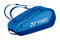 The Yonex 42526EX Team 6 Racket Tennis Bag in Blast Blue features adjustable shoulder straps, a zippered main compartment, and a shoe compartment. The Yonex logo is prominently displayed on the side.