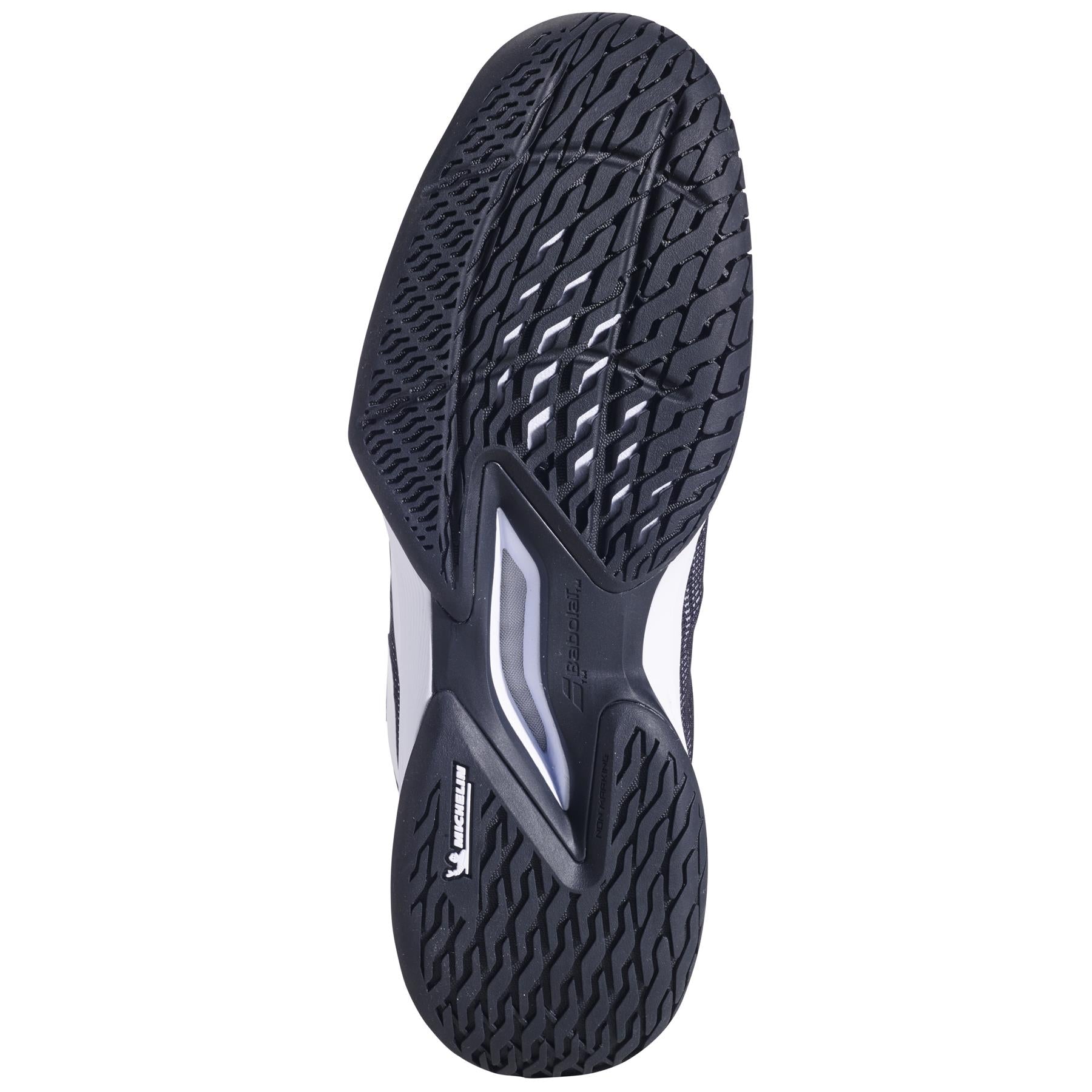 The image displays the sole of a Babolat Jet Tere 2 All Court 2025, an ultra-light tennis shoe in black/white. It features a textured waffle-like pattern with the Michelin logo, providing comfort and stability using smooth and ridged sections to ensure optimal grip.