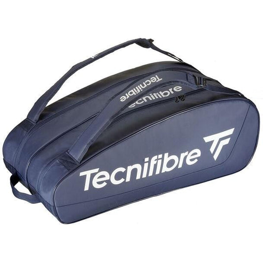 The Tecnifibre Tour Endurance 2023 12 Racket Tennis Bag in navy blue, crafted from durable tarpaulin material, showcases a striking design with dual handles and a zippered compartment. The Tecnifibre brand name and logo are prominently displayed in white on the side.