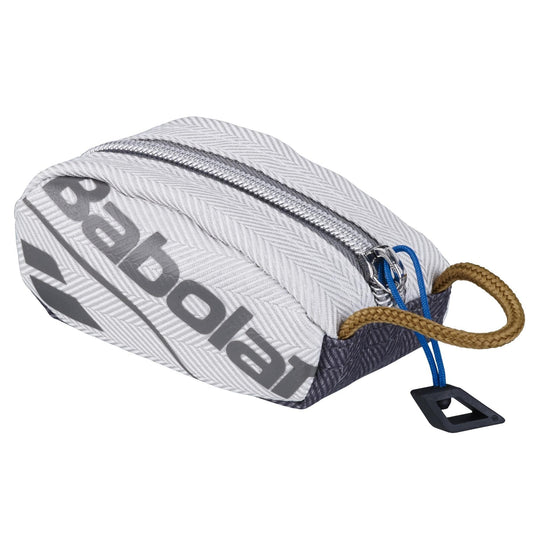 Introducing the Babolat Racket Holder Wimbledon Key Ring: a compact, zippered pouch showcasing a gray herringbone pattern. It features "Babolat" and the official Wimbledon 2024 logo printed in black. This stylish key ring is equipped with a blue zipper, a brown loop handle, and includes an attached black plastic tag.