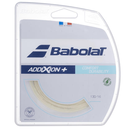 Close-up of Babolat Addixion+ Multifilament Tennis String - Natural package shows the brand logo, labeled for "comfort durability," with a French flag symbol, "environment-friendly packaging" text, and its solvent-free design for enhanced comfort.