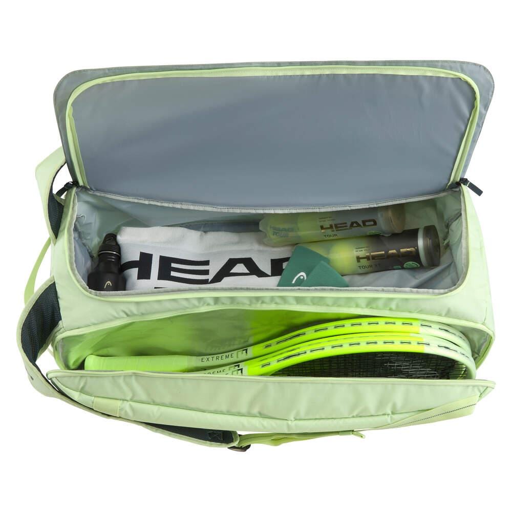 The HEAD Pro Duffle Tennis Bag L - LLAN by HEAD, in light green with a black strap, includes several compartments. Inside, it holds tennis rackets, a towel, drink bottles, and balls. This bag provides organized storage for sports gear and suggests climate control technology to maintain optimal equipment conditions.