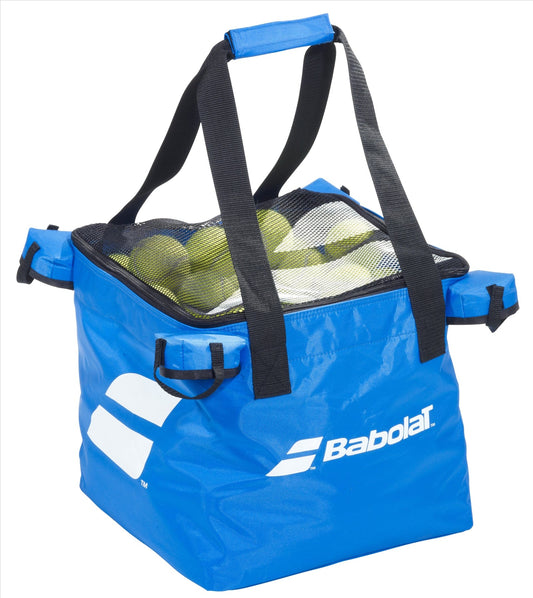 The Babolat Tennis Ball Bag, available in blue, is ideal for practice sessions, featuring a convenient carry strap and mesh top. It contains tennis balls and showcases a prominent white Babolat logo on the side.