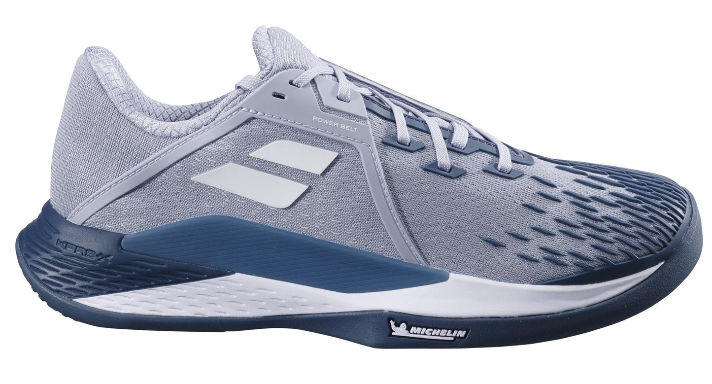 The Babolat Propulse Fury 3 Sand & Grass Court 2025 Men's Tennis Shoes in grey and white feature a textured design, branded logo, Michelin Original rubber sole, and a cushioned base for support. Made with mesh and synthetic materials, they are perfect for athletic performance.