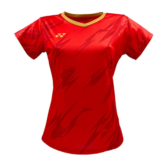 The Yonex YTL8 Women's Tennis T-Shirt in red/gold features a moisture-wicking polyester fabric with a bold zigzag pattern, a small yellow logo on the left chest, and a contrasting yellow collar, offering a modern fit perfect for keeping cool on the court.