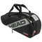 The HEAD Team 6 Racket Tennis Bag M - BKCC, designed with a sleek black and gray color scheme, prominently displays the brand name "HEAD" on its side. It comes with robust black handles and a versatile 2-way carry system. Additional storage compartments are highlighted by the word "TEAM" and a subtle logo, adding an elegant touch to the bag.