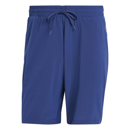 ADIDAS Ergo Mens Tennis Shorts in Navy feature a relaxed fit with a textured fabric. Crafted from recycled materials, they include an elastic waistband and front drawstring, making them the perfect lightweight choice for any game.