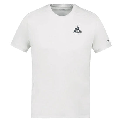 The Le Coq Sportif Pro Men's Tennis T-Shirt in Optical White, by K-Swiss, showcases a small "Le Coq Sportif" logo on the upper left chest and sleeve. Made from breathable polyester, this shirt offers a timeless design featuring short sleeves and a round neckline to ensure freedom of movement during play.