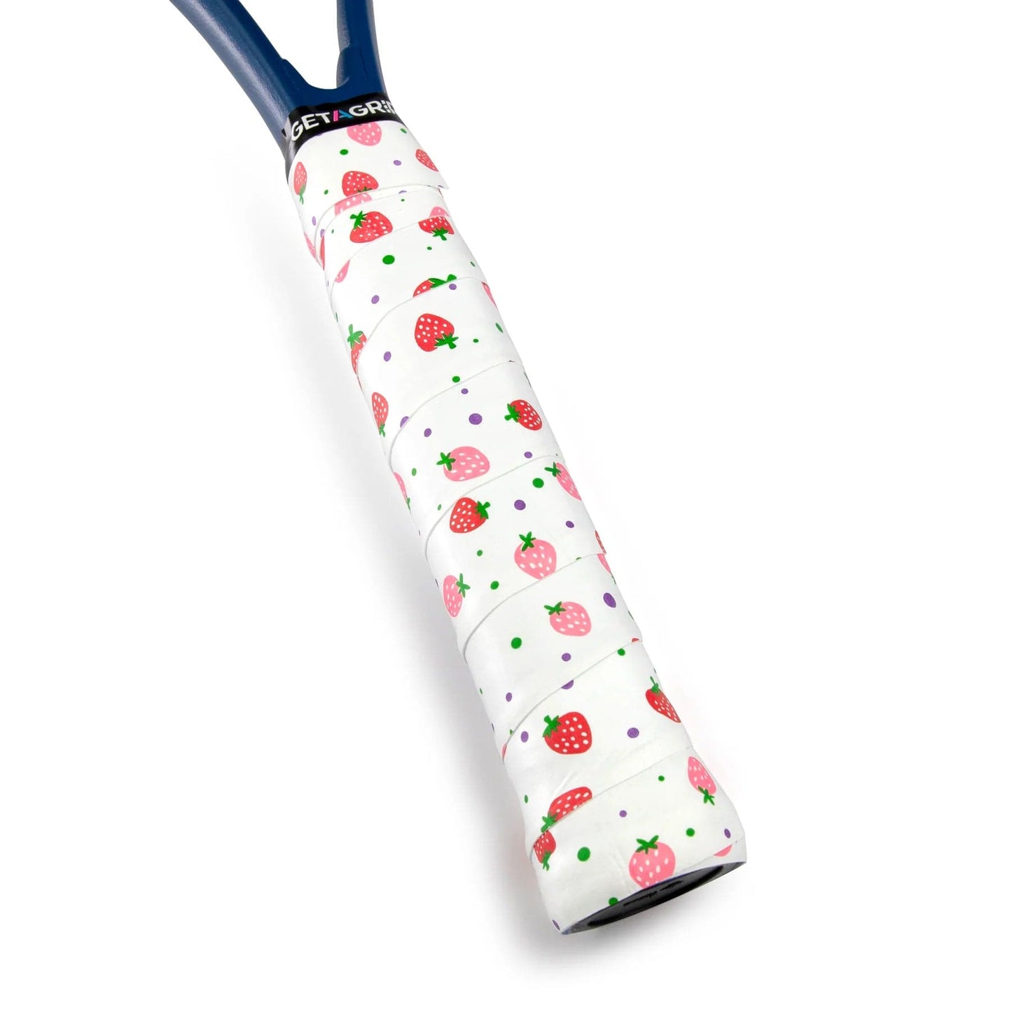 The image features the handle of a tennis racket wrapped in the Get A Grip Strawberries & Cream Tennis Overgrip by Get A Grip. This premium non-slip, white overgrip is decorated with a design of red strawberries with green leaves, along with small green and purple dots. The frame of the racket is a vibrant blue.