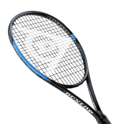 The Dunlop FX 500 Tour Tennis Racket - Black / Blue (Frame Only) is artfully angled against a white background, showcasing its sleek blue accent on the frame and tightly strung net. The "Dunlop" brand name is elegantly printed in white on its Sonic Core handle, emphasizing its power boost design.