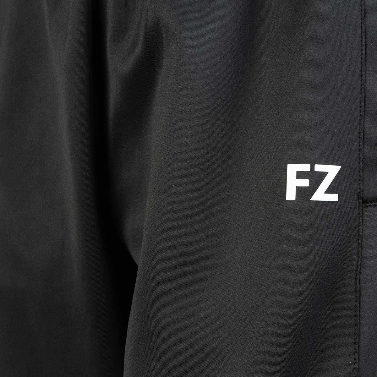 Close-up image of FZ Forza Plymount Women's Pants in black fabric, featuring the initials "FZ" in white on the right side and showcasing its Dryforze technology, which is perfect for badminton clothing.