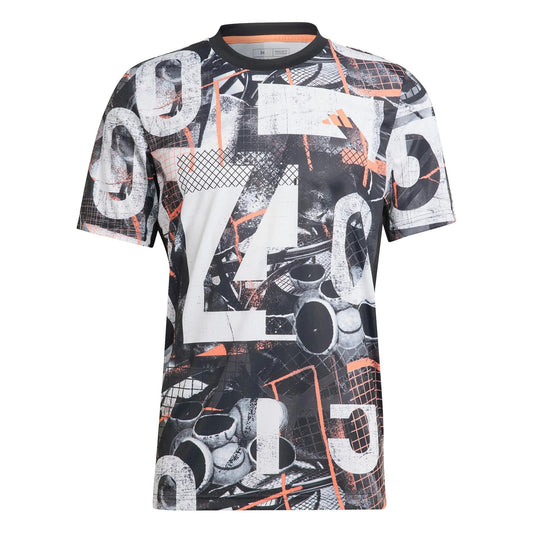 The adidas Club Men's Graphic Tennis T-Shirt - White / Black is made from recycled polyester and features a striking abstract black and white pattern with prominent numbers and geometric shapes. Subtle hints of orange enhance the vibrant design, while AEROREADY moisture-wicking technology helps keep you cool during your game.