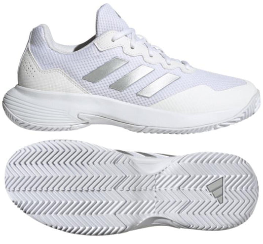 A pair of adidas GameCourt 2.0 women's tennis shoes in cloud white with silver metallic stripes, featuring a mesh upper and textured rubber soles. These shoes offer lightweight cushioning for a sporty design ideal for athletic activities.