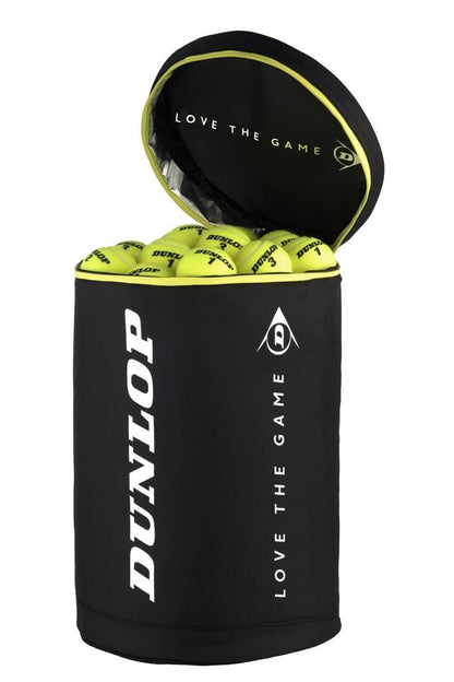 A Dunlop Tennis Ball Basket Bag 2020 in black rests with its top open, showcasing a collection of vibrant yellow tennis balls. Ideal for coaches, it features the Dunlop logo and the motivational phrase "Love the Game" in elegant white lettering.